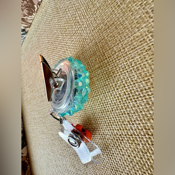 Smiling Daisy Glitter Badge Reel with Orange Butterfly Charm - Picture 4 of 4